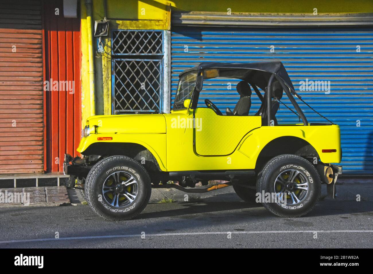 Yellow jeep parks in the street Stock Photo Alamy