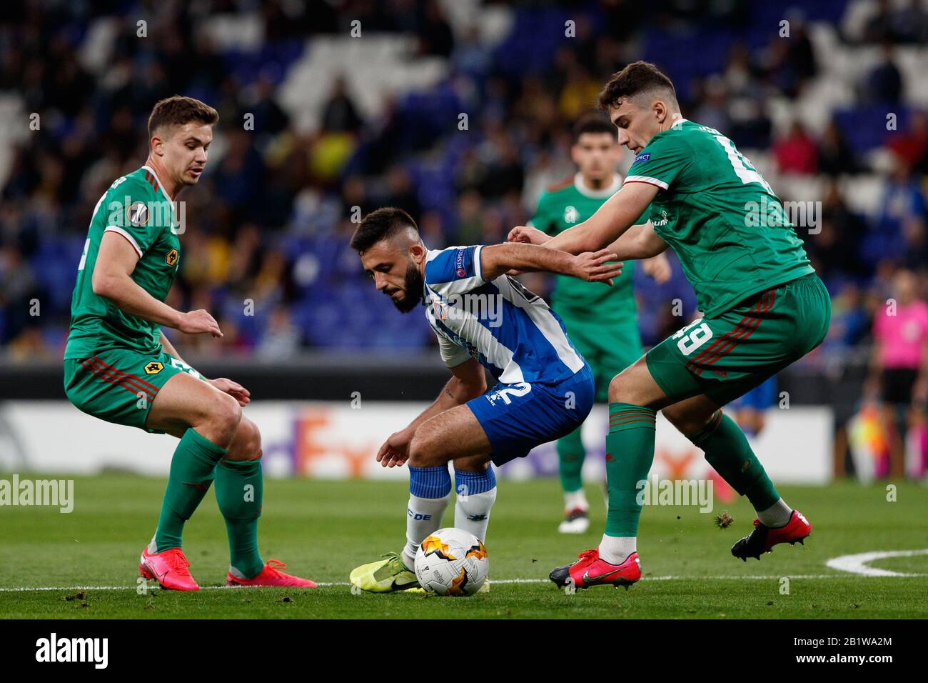 Barcelona, Spain. 27th Feb 2020.  Matias Vargas of RCD Espanyol in action with Max Kilman and Leander Dendoncker of Wolverhampton Wanderers F.C. during the UEFA Europa League round of 32 second leg match between RCD Espanyol and Wolverhampton Wanderers at RCD Stadium on February 27, 2020 in Barcelona, Spain. Credit: Dax Images/Alamy Live News Stock Photo