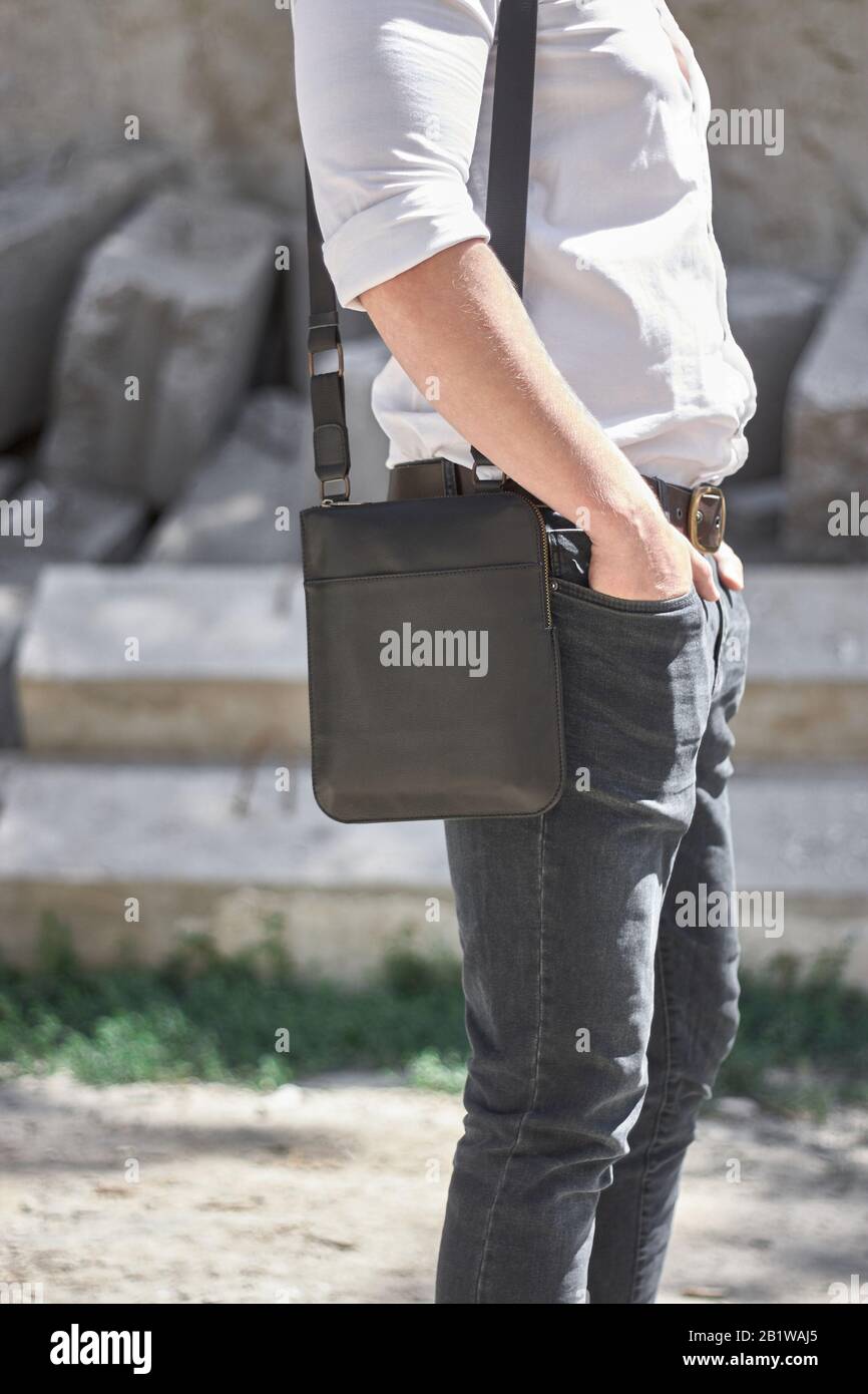 Man with a leather black bag on the street. Stock Photo