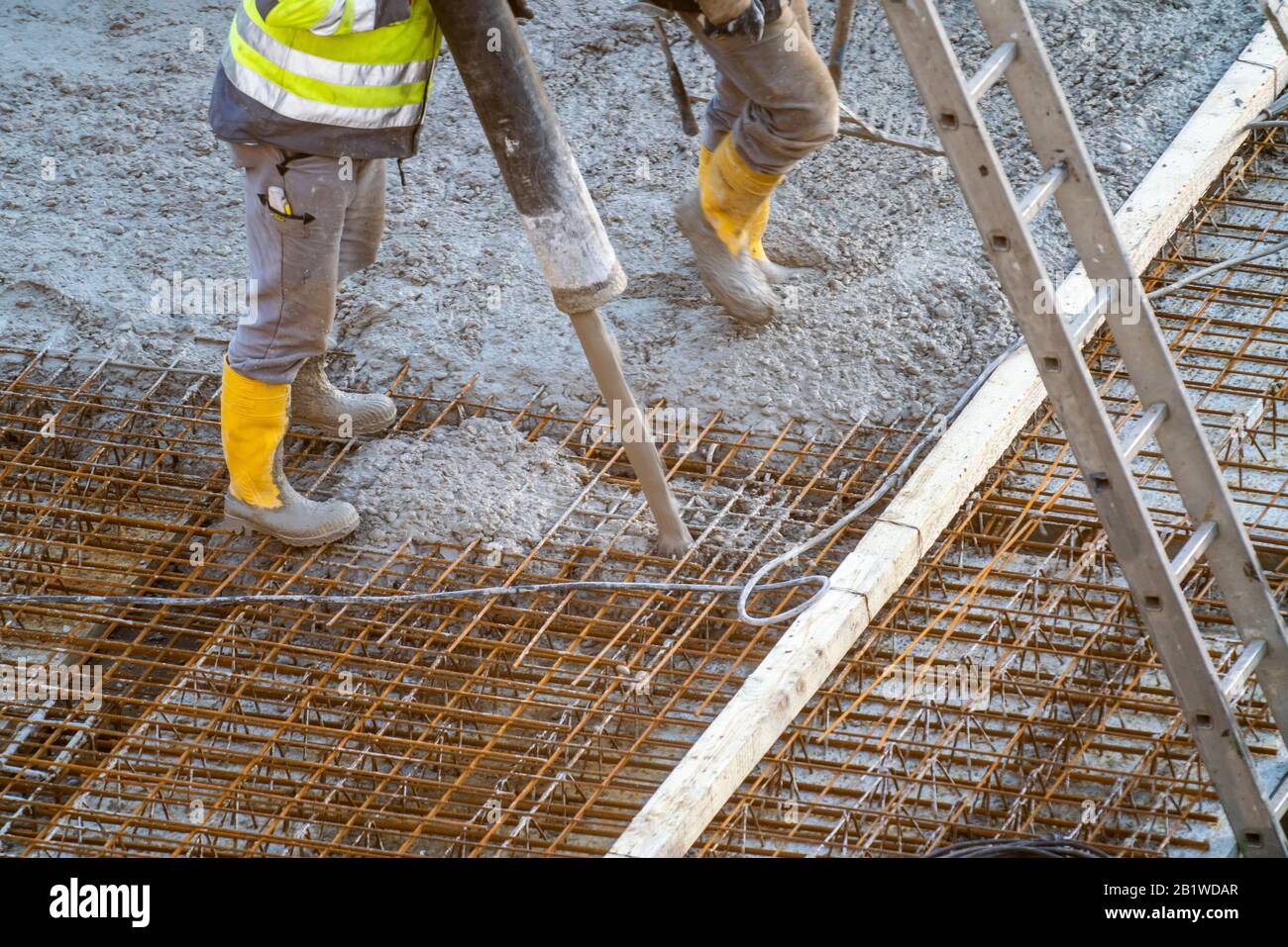 Construction site, concreting, floor, ceiling for a building is concreted, the concrete is pumped onto the reinforced concrete mats, Stock Photo