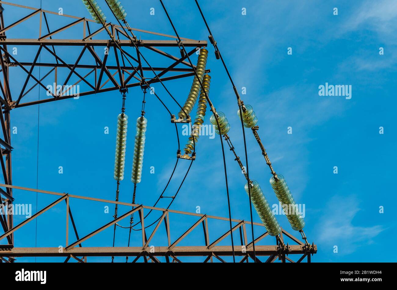 Many insulators on the wires of a tower of a high voltage power line ...