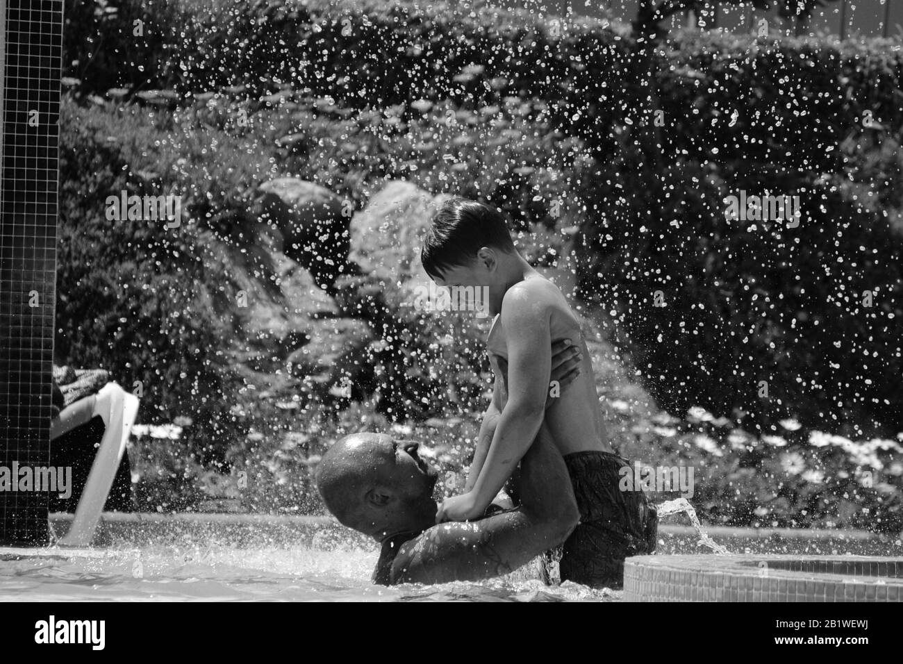 Happy father and son in the pool. Stock Photo