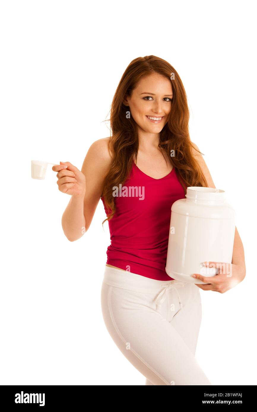 Attractive beautiful sporty woman holds blank plastic protein container Stock Photo