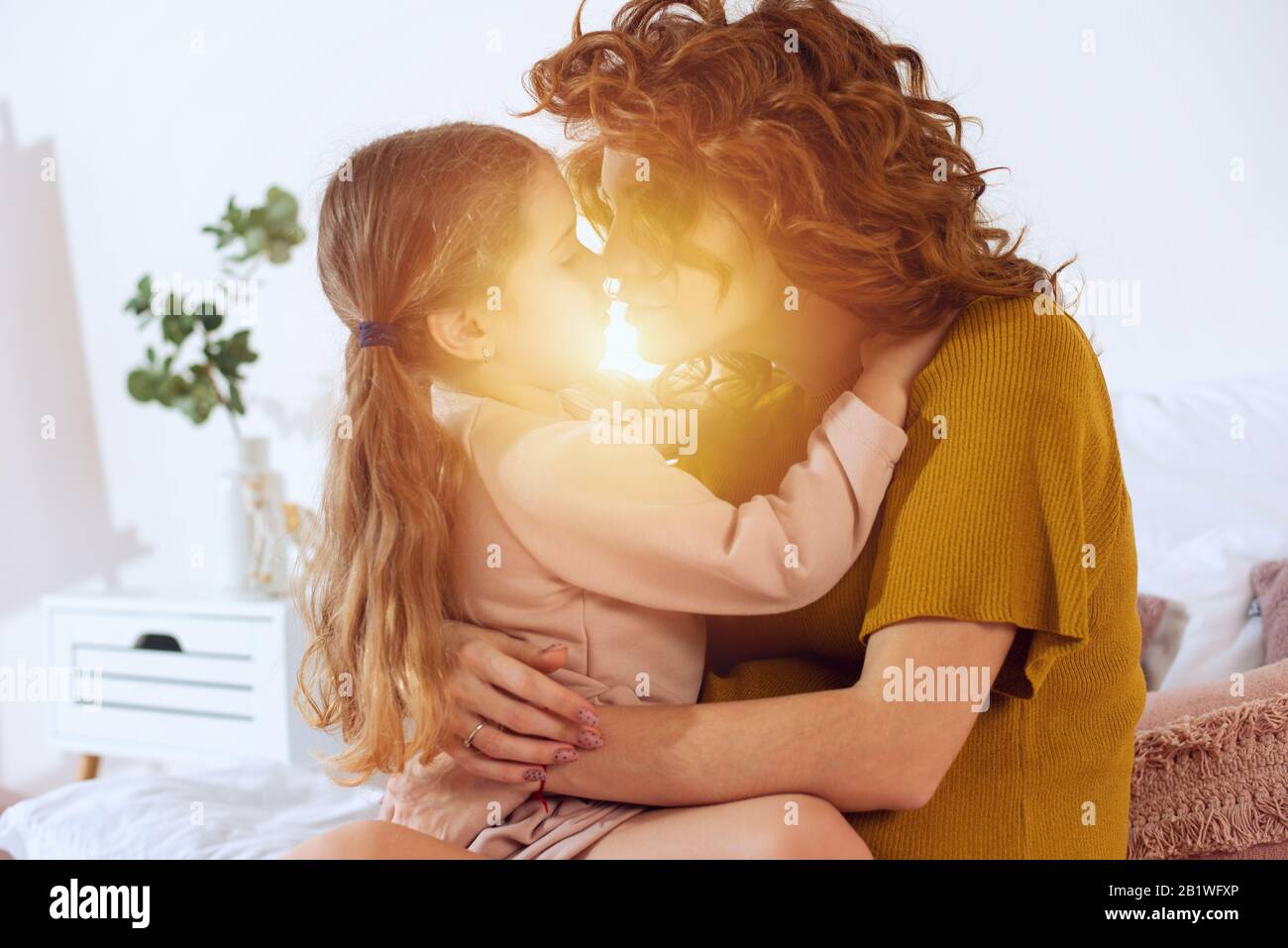 Pregnant mom plays with her daughter. Concept of family, joy and pregnancy Stock Photo