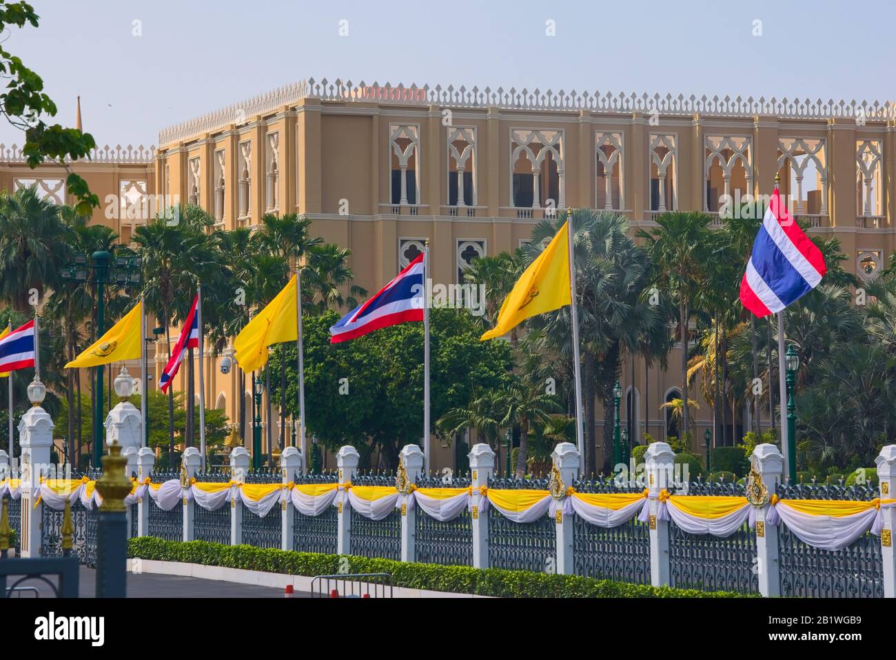 National and royal flags of Thailand flown at the front of the Government House of Thailand, in Bangkok. Stock Photo