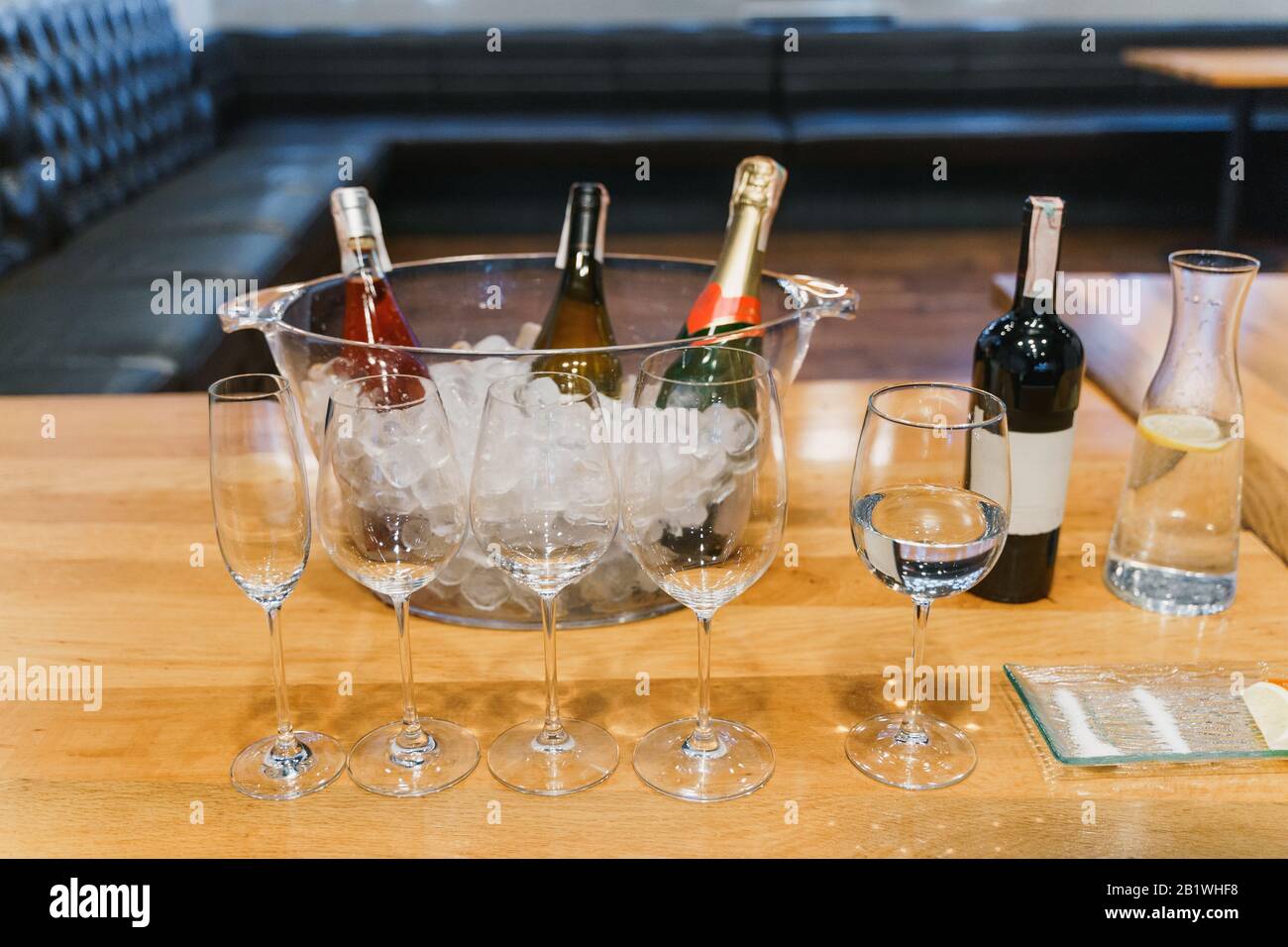 Empty glasses, bottle of assorted wine in a bowl with ice Stock Photo
