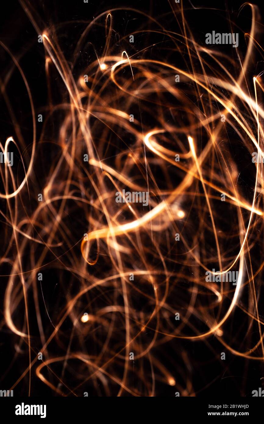 Long exposure underexposed photo of lightpainting bengali fire. Lighdrawing photo. Soft focus and a lot of lines. Stock Photo