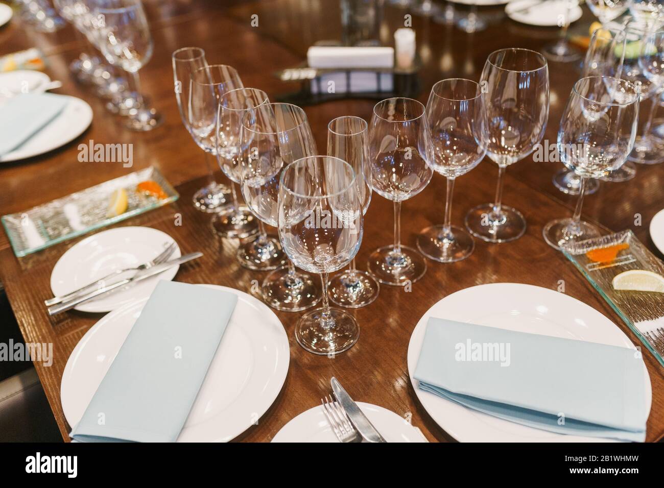 Empty glasses, white plates, cutlery and tableclothes Stock Photo