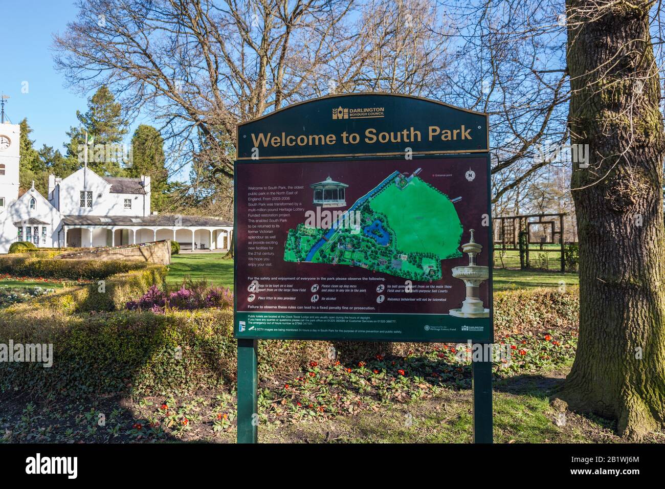 The entrance sign in front of the pavillion and clock tower in the