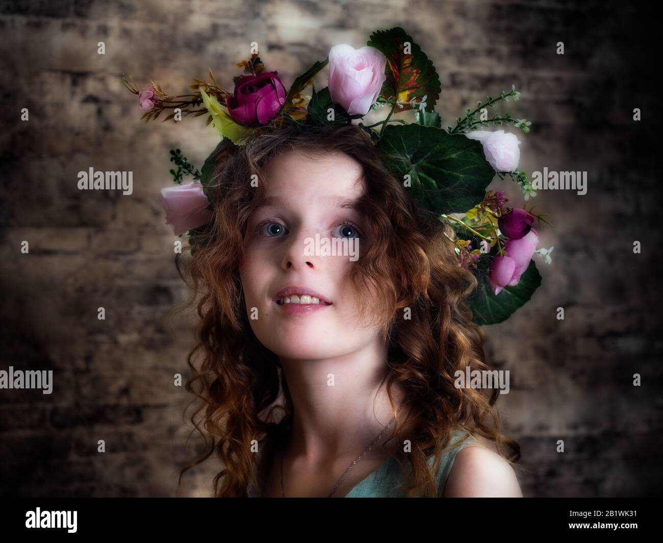 Portrait of a girl in a wreath of bright roses Stock Photo - Alamy