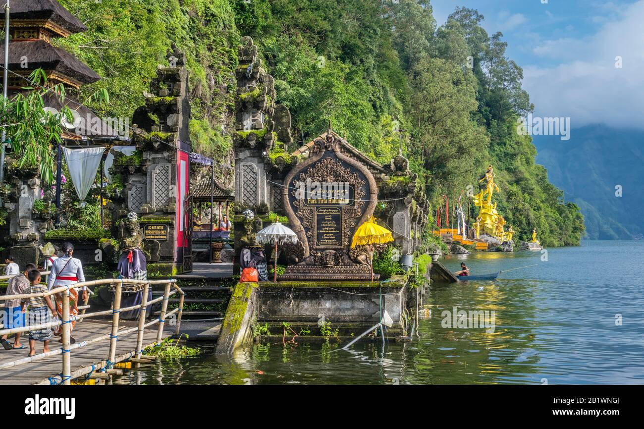 Pura Tirta Hulundanu hindu temple on the shores of Lake Batur with the gilded statue of Dewi Danu, the goddess of the lake in the background, Kintaman Stock Photo