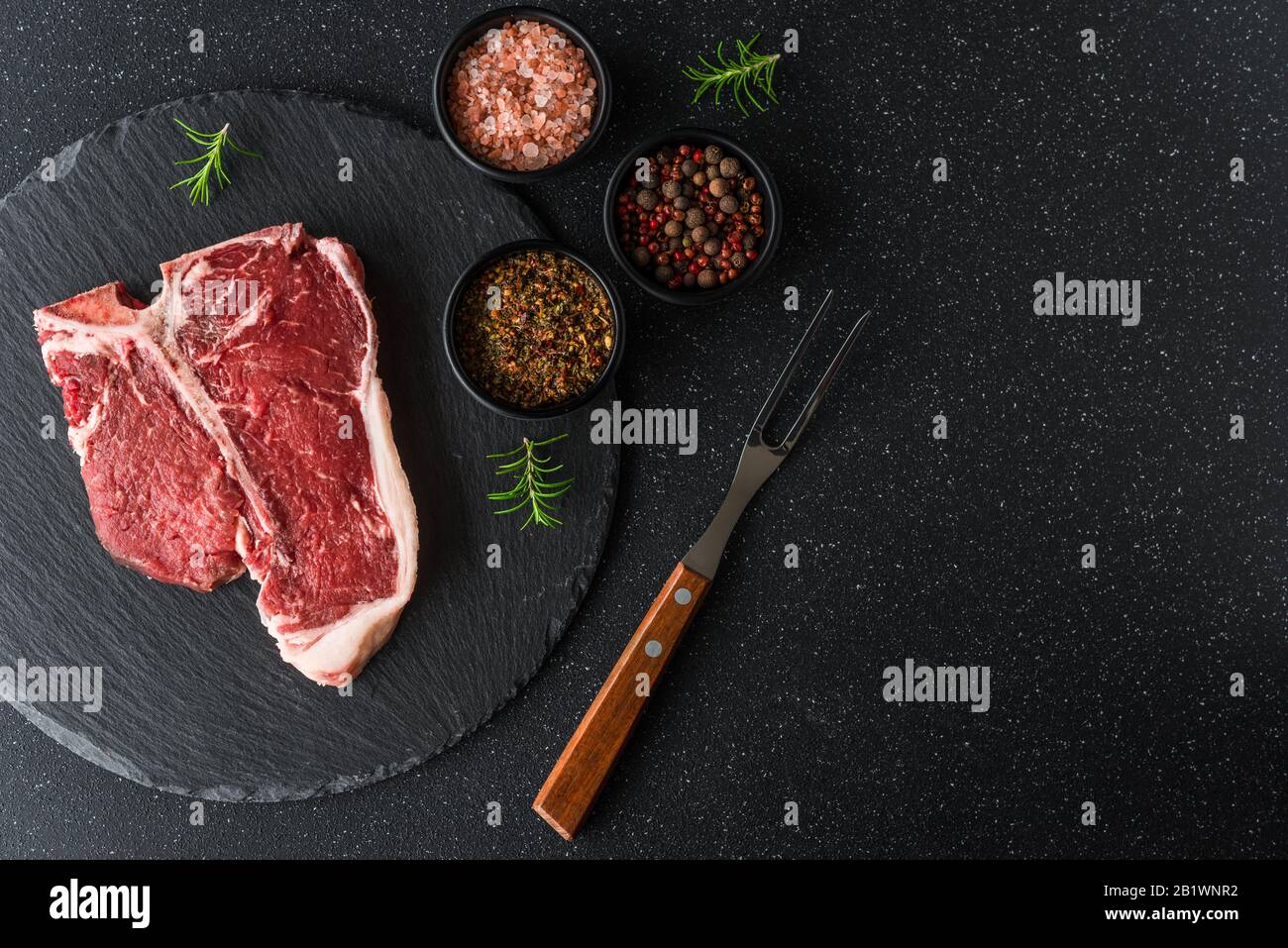 Raw t-bone porterhouse beef steak meat with chimichurri sauce. Stock Photo