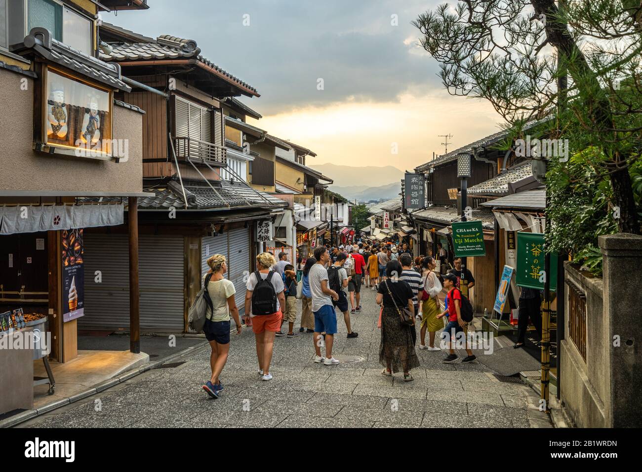Kyoto, Japan, August 18, 2019 – Tourists walking in a typical pedestrian street near  Kiyomizudera temple at sunset Stock Photo