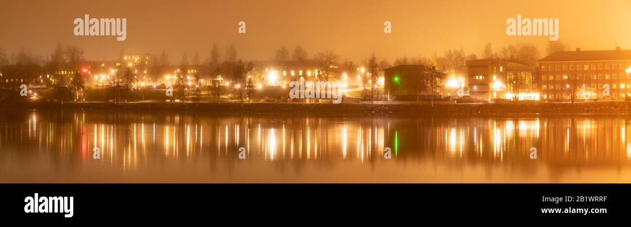 Still foggy night - view over the river to the old side of central Umea city, Vasterbotten municipality, Sweden Stock Photo