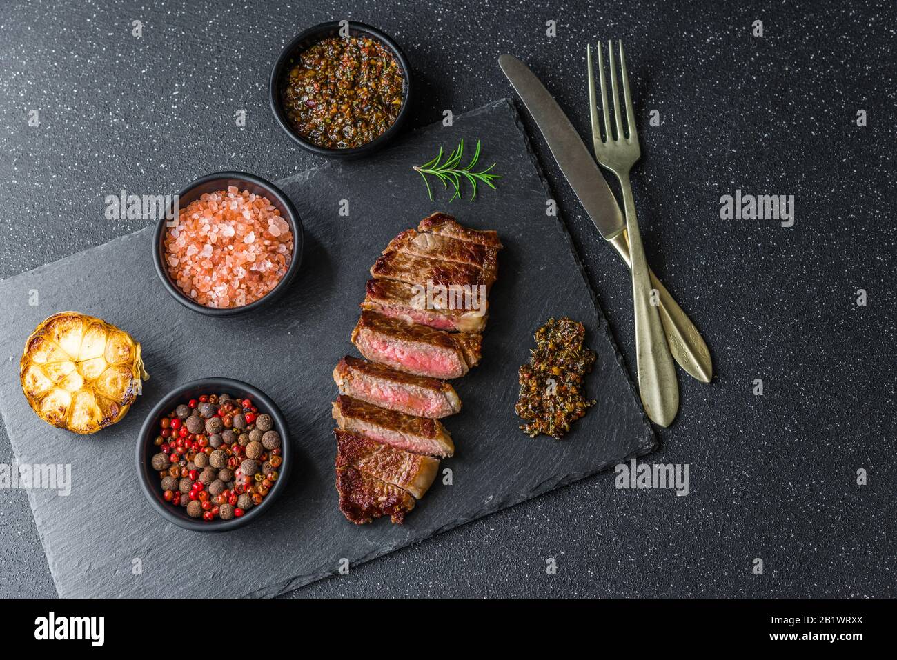 New york strip loin beef steak meat with chimichurri sauce. Stock Photo