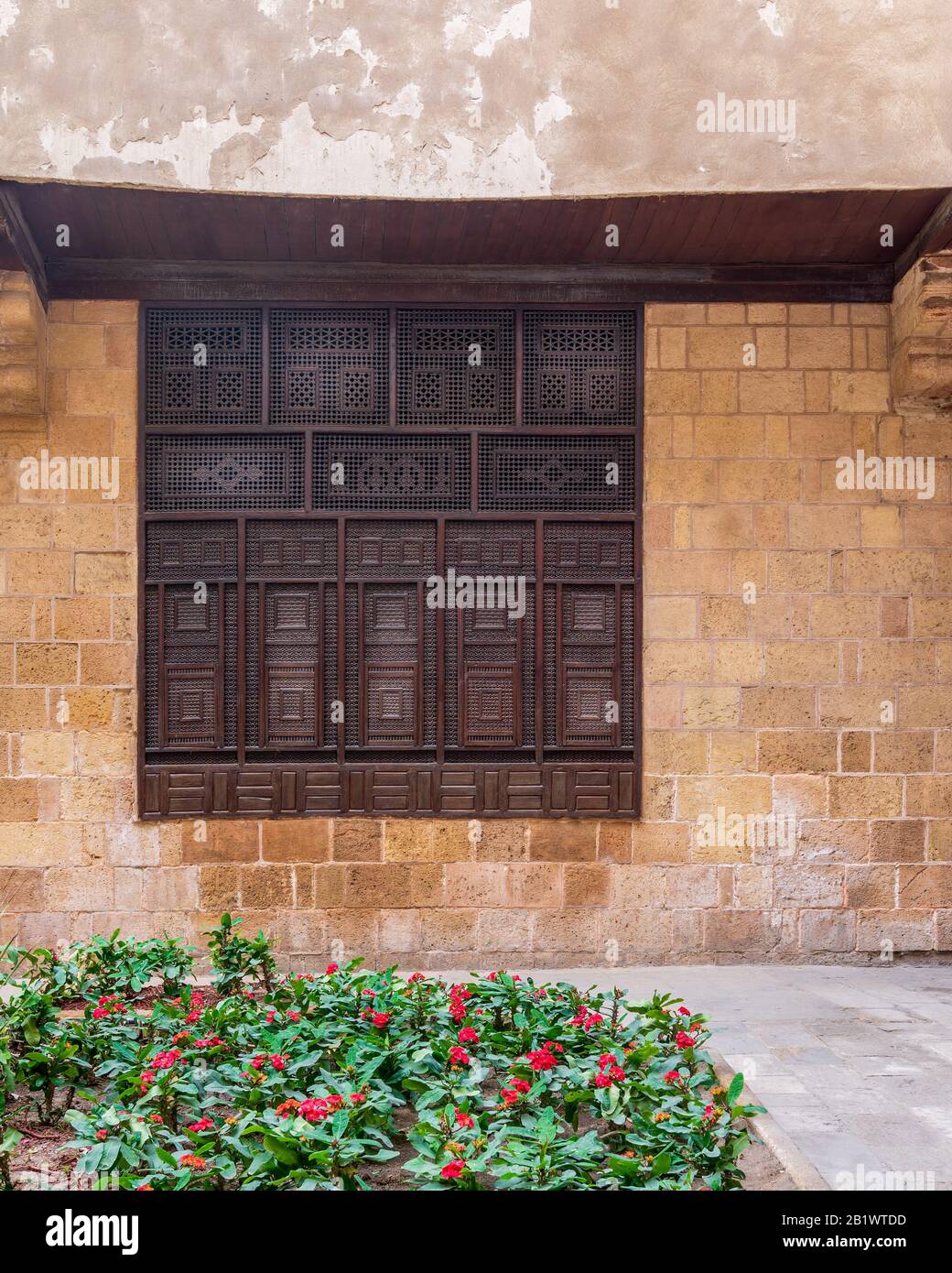 Wooden arabesque window, Mashrabiya, in exterior stone bricks wall of ottoman era old historic El Sehemy building, Moez Street, Cairo, Egypt Stock Photo