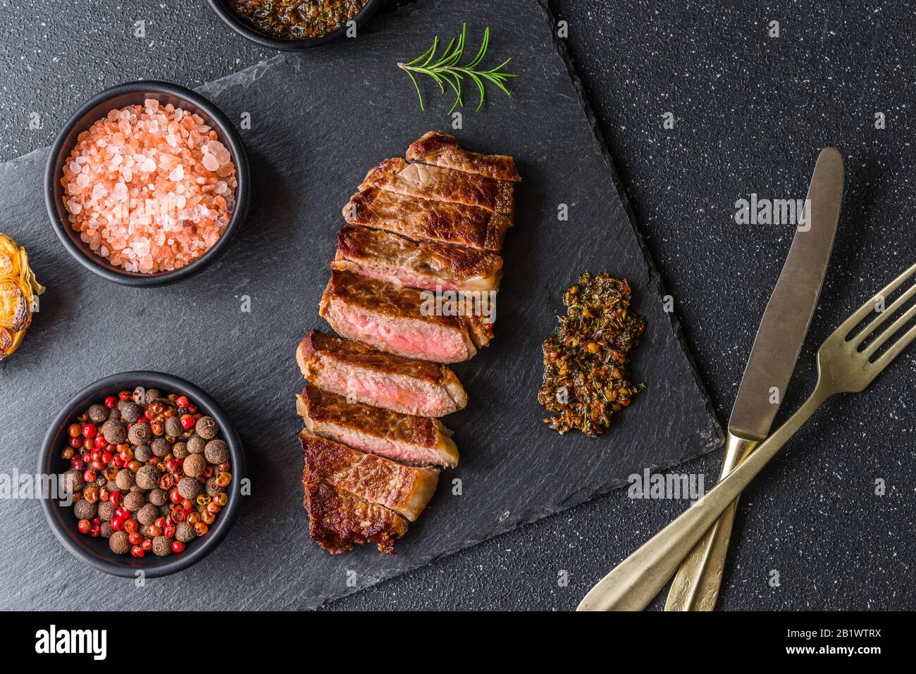 New york strip loin beef steak meat with chimichurri sauce Stock Photo
