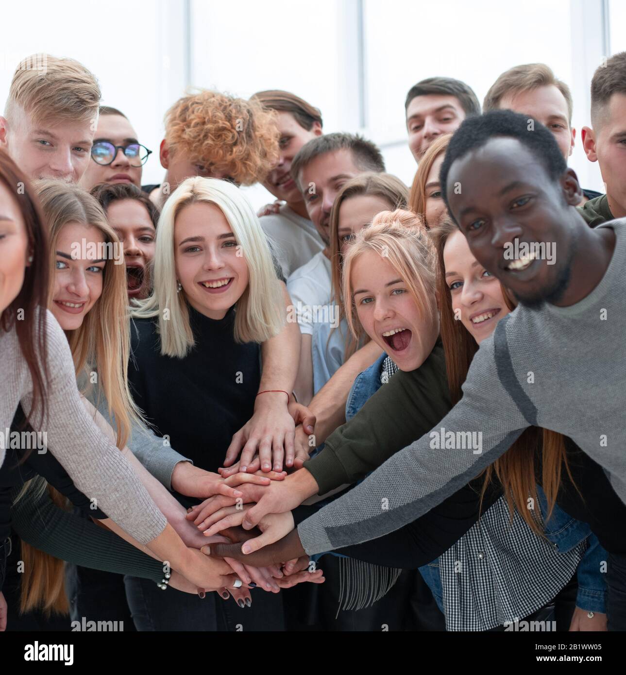 diverse young people putting their hands together Stock Photo - Alamy