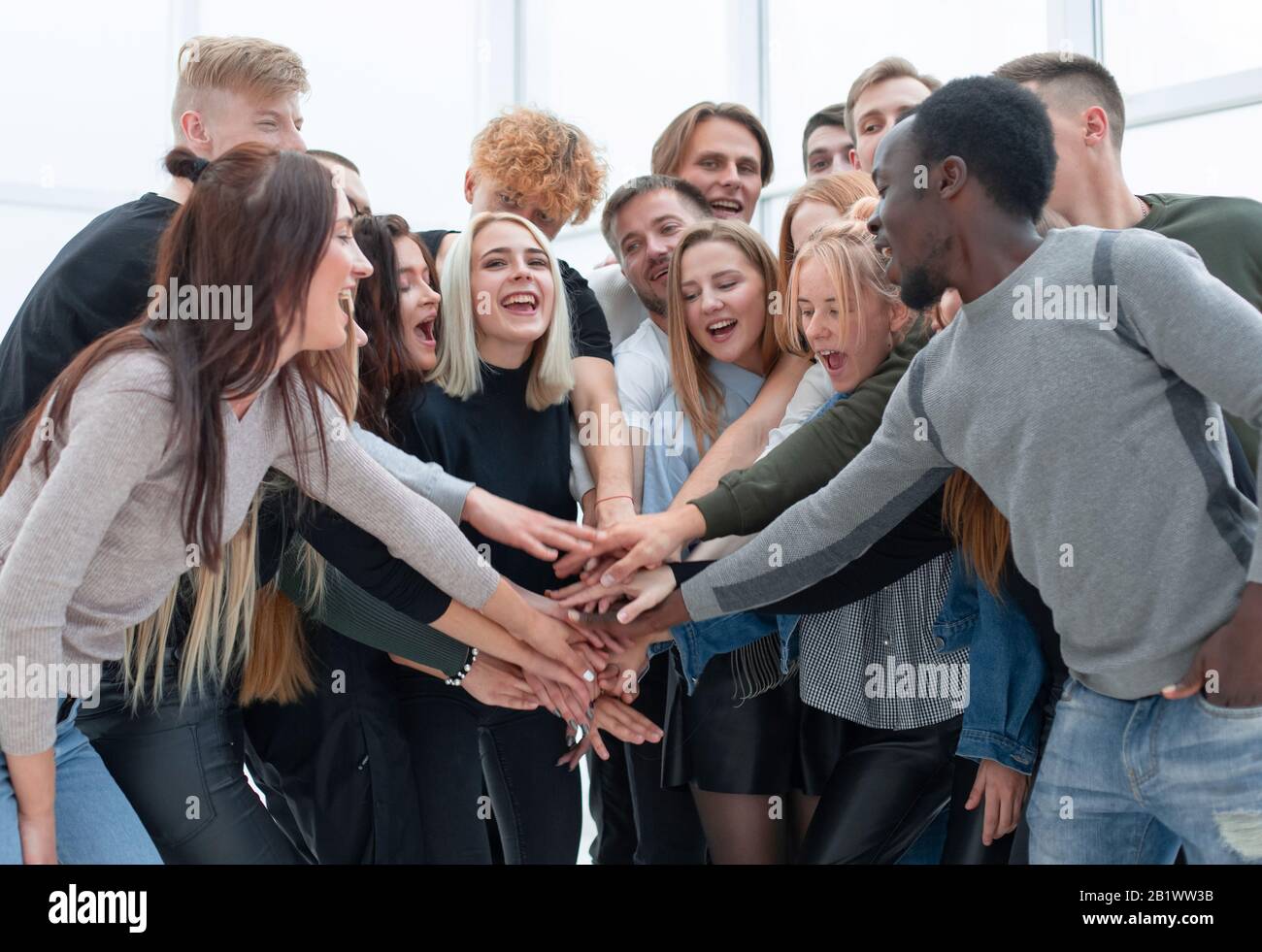 diverse young people putting their hands together Stock Photo - Alamy