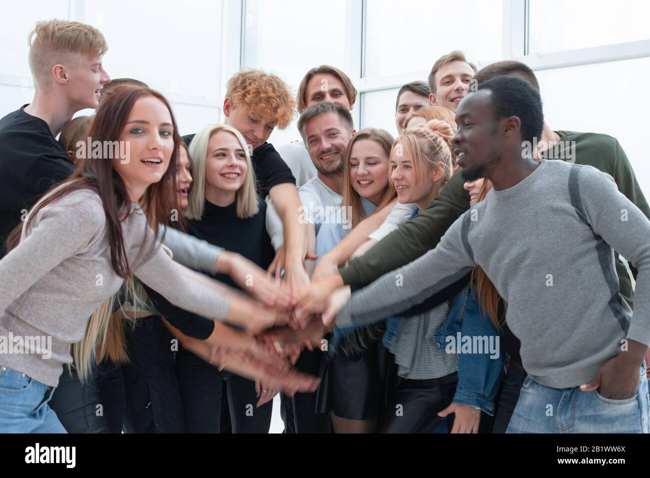 diverse young people putting their hands together Stock Photo - Alamy