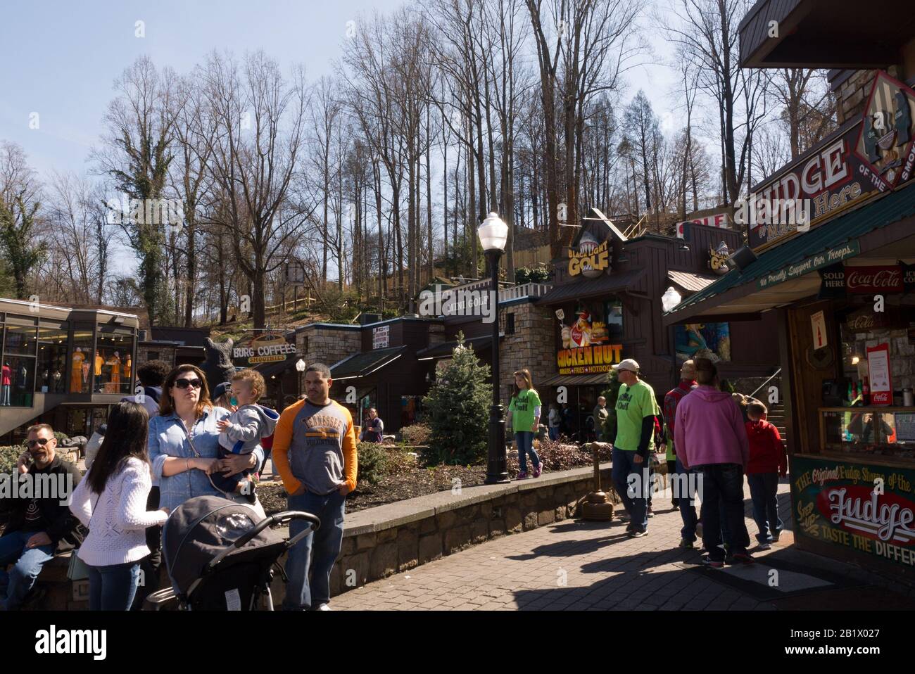 A crowd of people mingle around the stores in downtown Gatlinburg, Tennessee Stock Photo