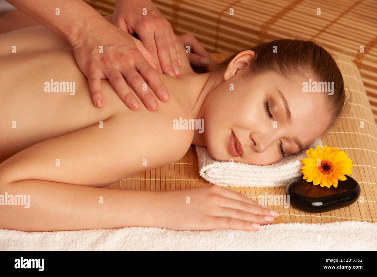Beautiful young woman having a massage treatment in spa salon - wellness . Stock Photo