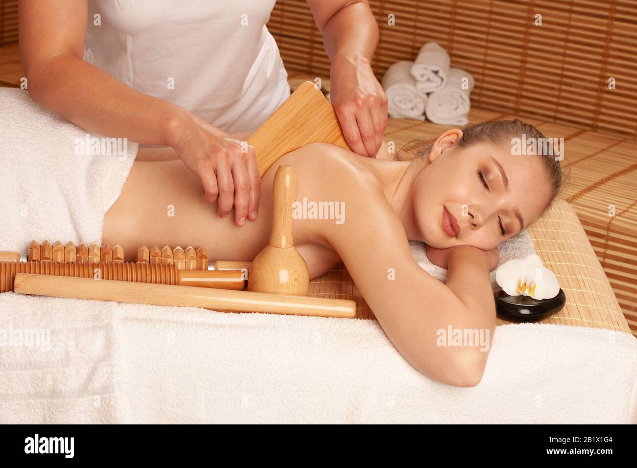 Beautiful young woman having a maderotherapy massage  treatment in spa salon - wellness Stock Photo