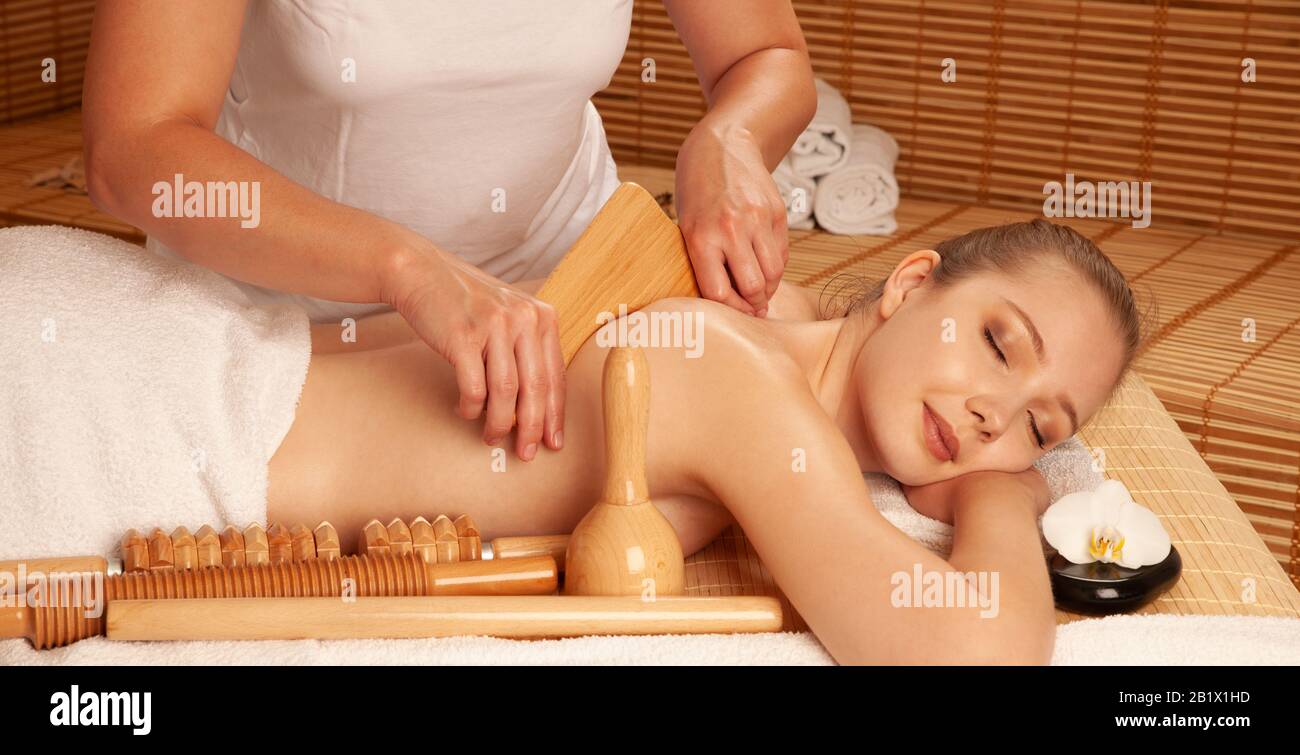 Beautiful young woman having a maderotherapy massage  treatment in spa salon - wellness Stock Photo