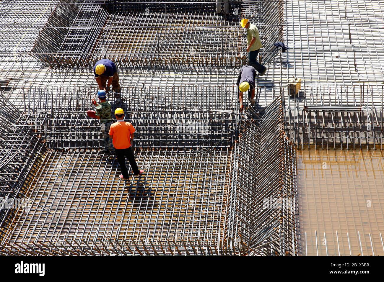 worker in the construction site making reinforcement metal framework ...