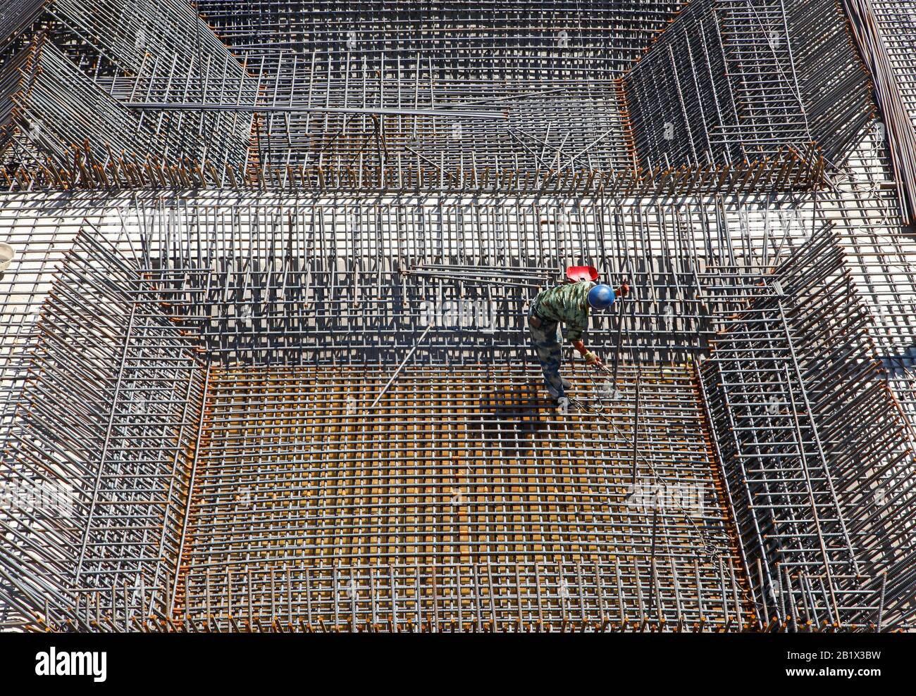 worker in the construction site making reinforcement metal framework ...