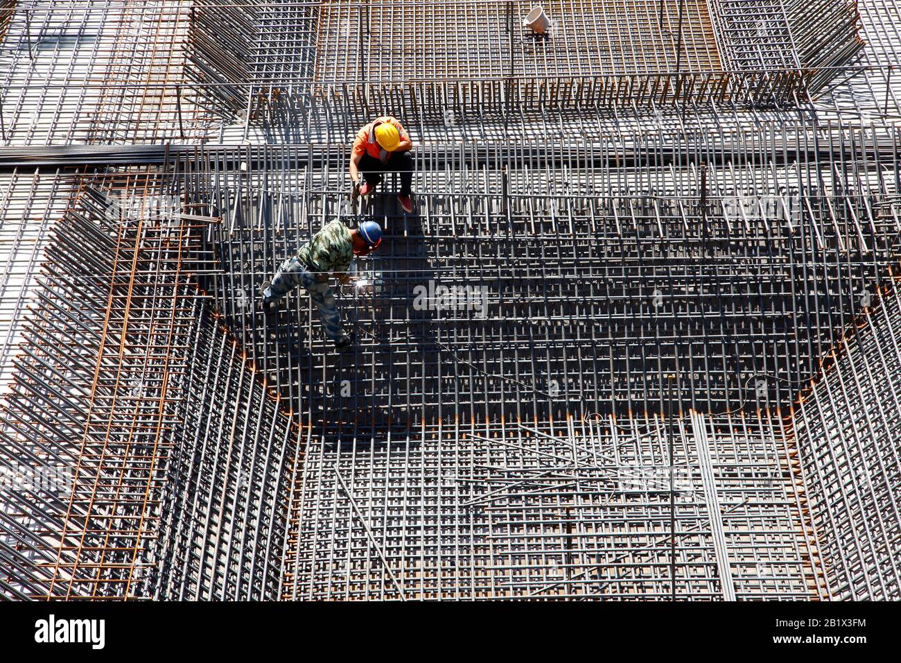 worker in the construction site making reinforcement metal framework ...