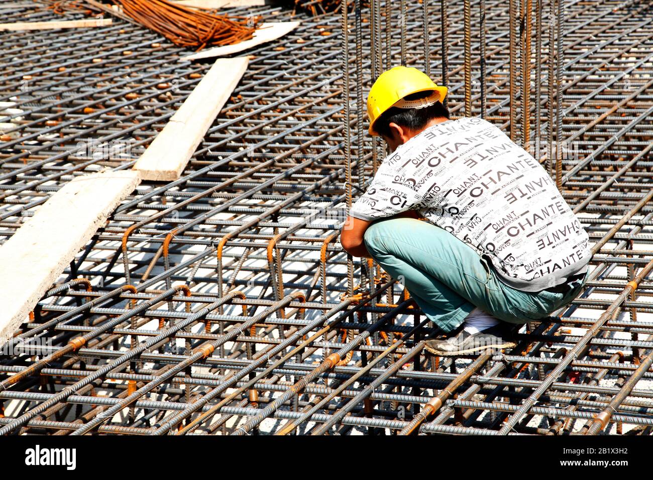 worker in the construction site making reinforcement metal framework ...