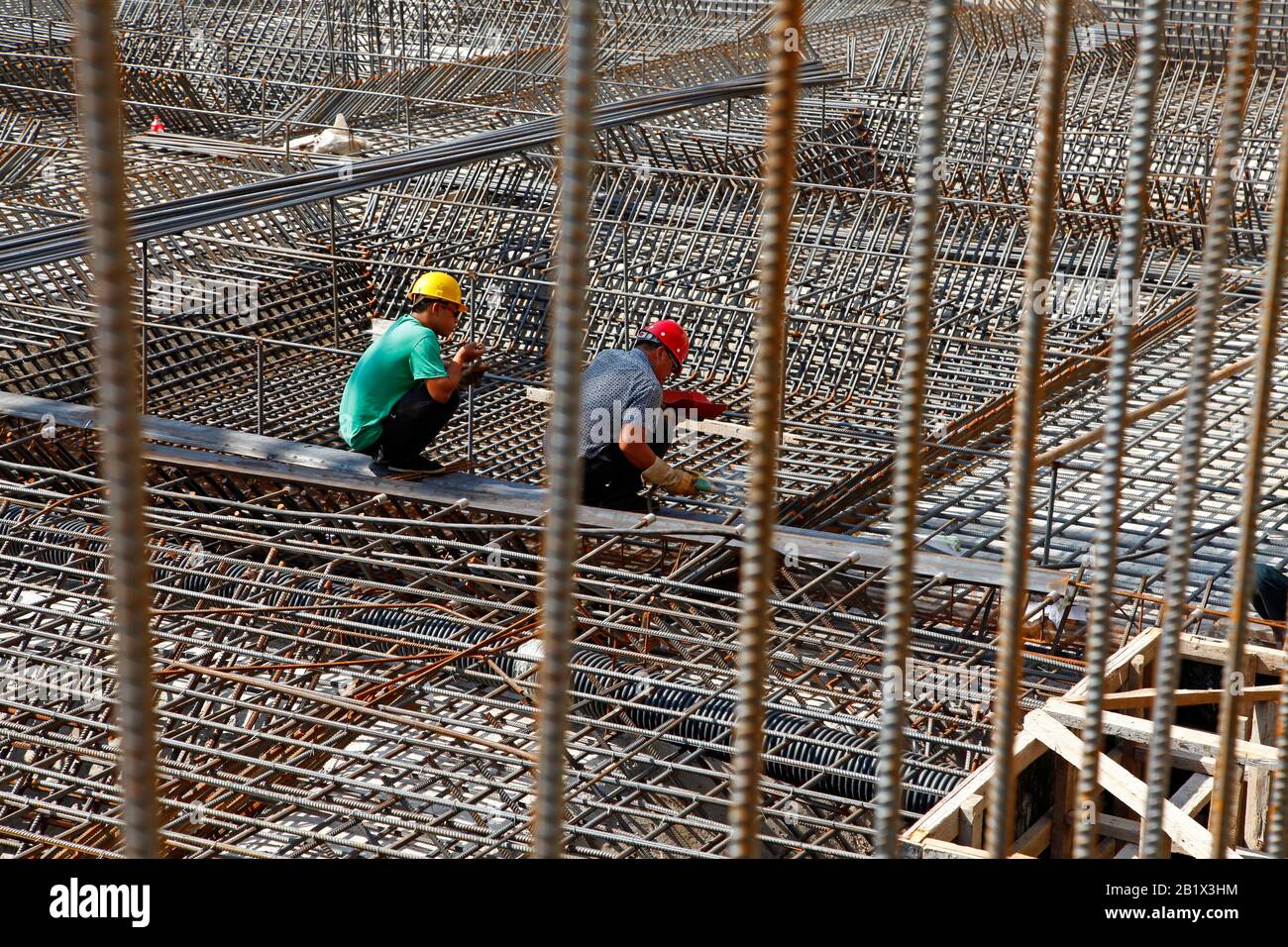 worker in the construction site making reinforcement metal framework ...