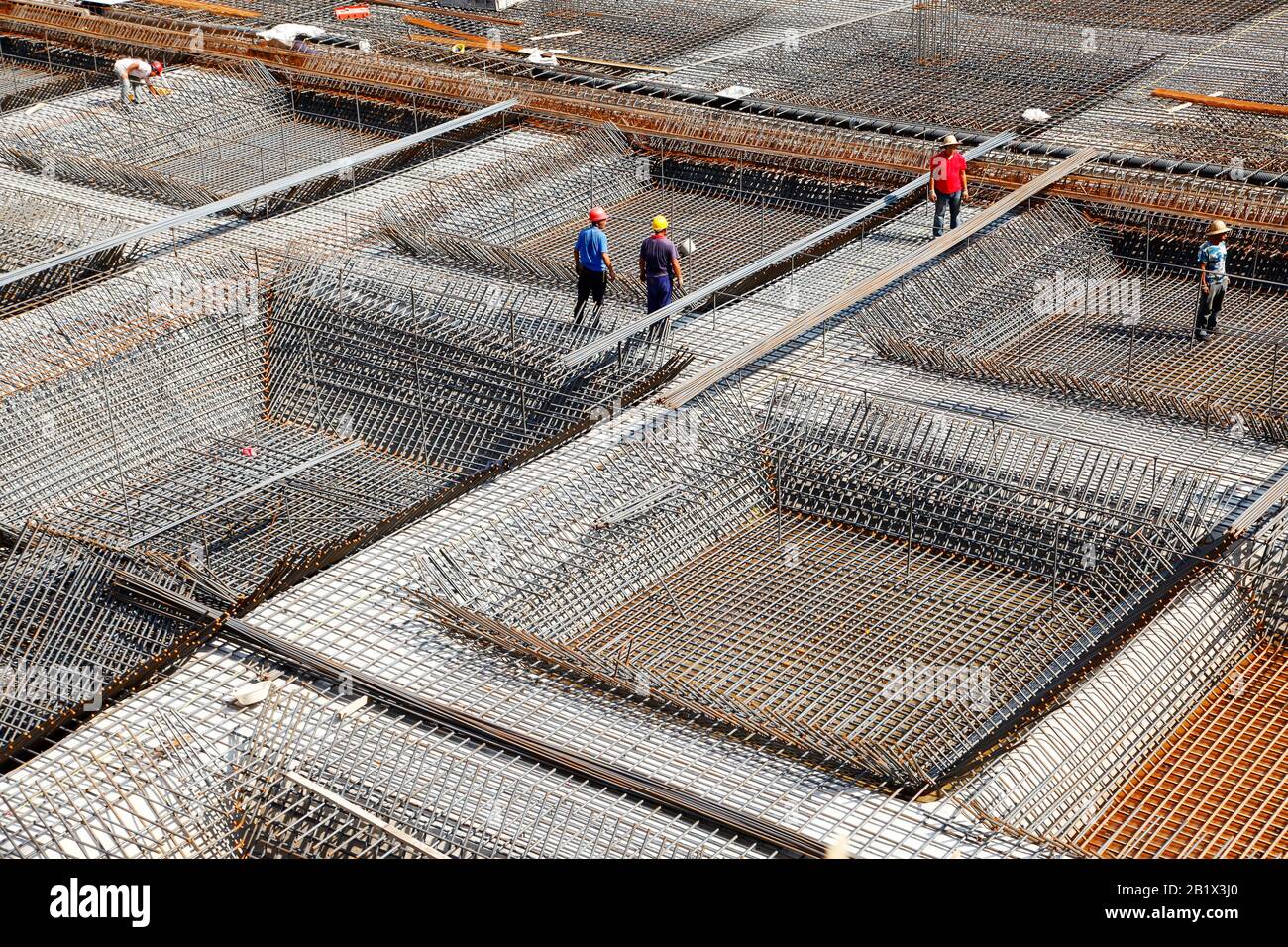 worker in the construction site making reinforcement metal framework ...