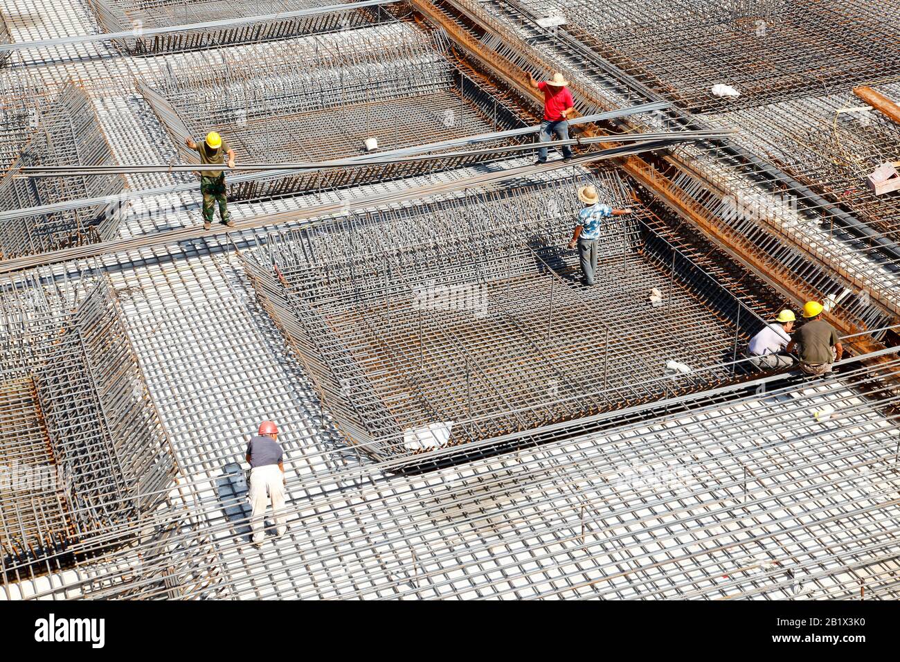 worker in the construction site making reinforcement metal framework ...