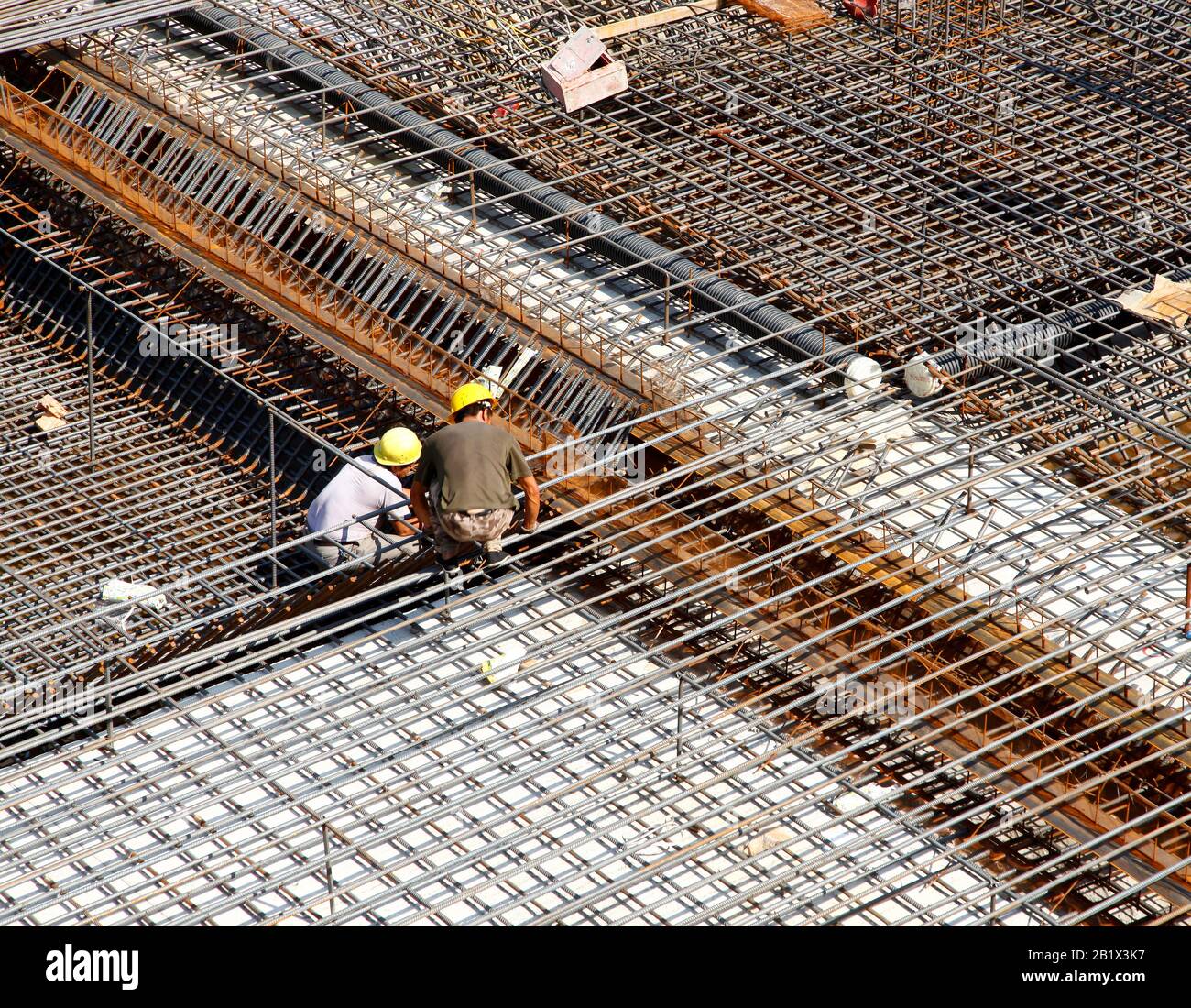 worker in the construction site making reinforcement metal framework ...