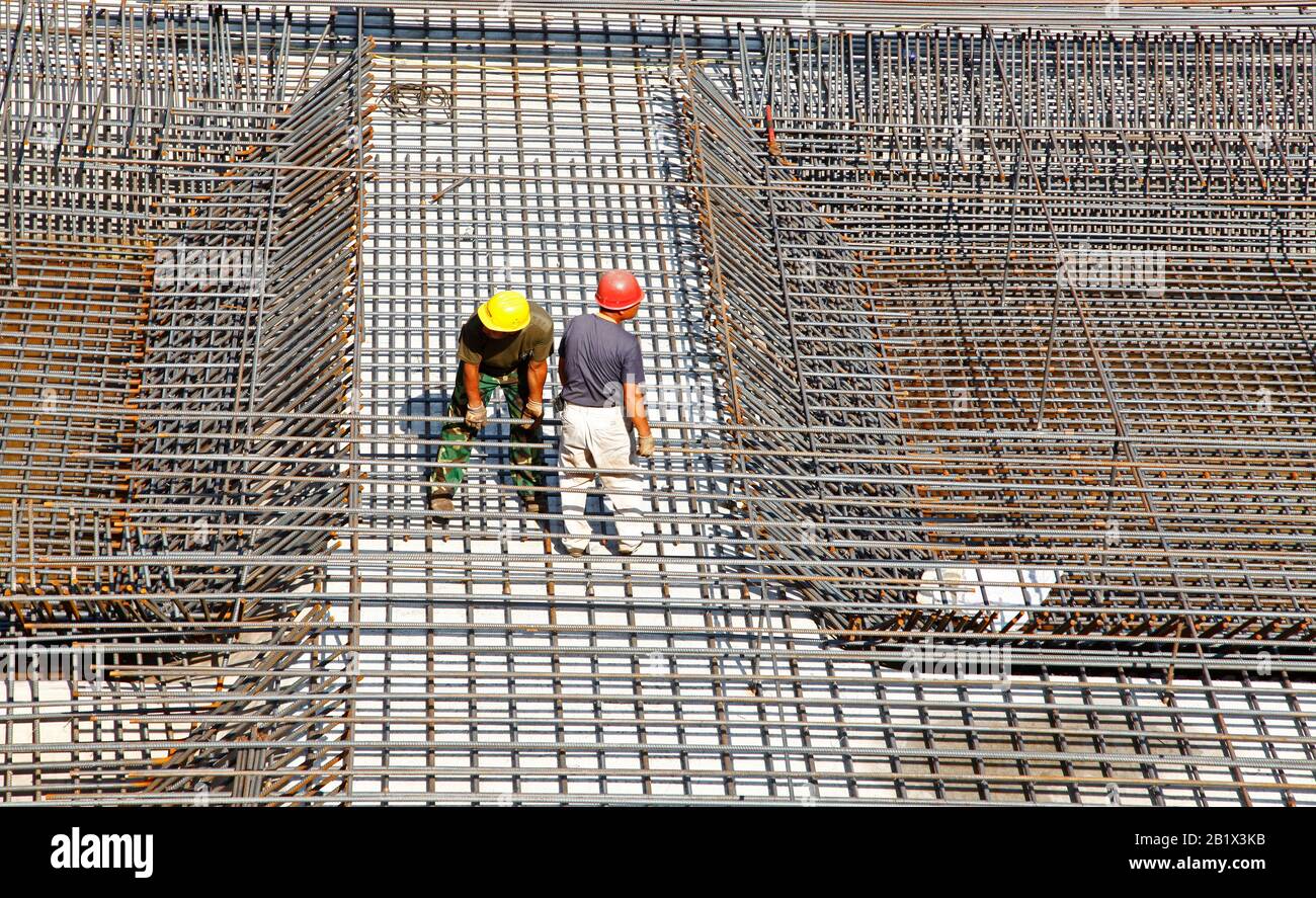 worker in the construction site making reinforcement metal framework ...