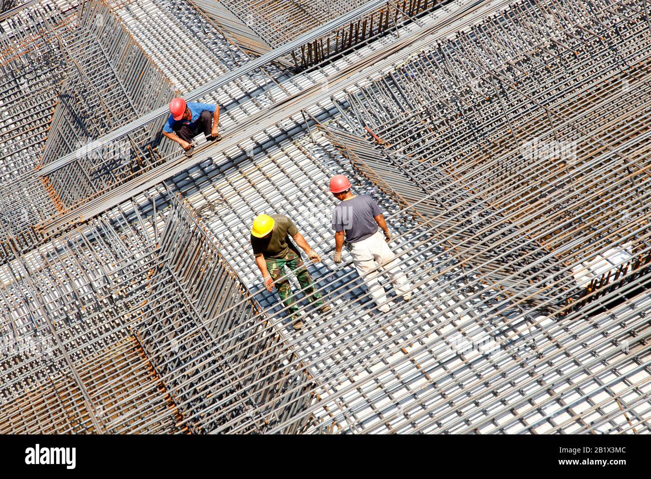 worker in the construction site making reinforcement metal framework ...