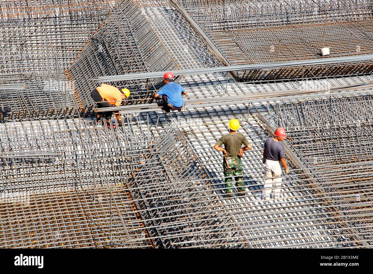 worker in the construction site making reinforcement metal framework ...