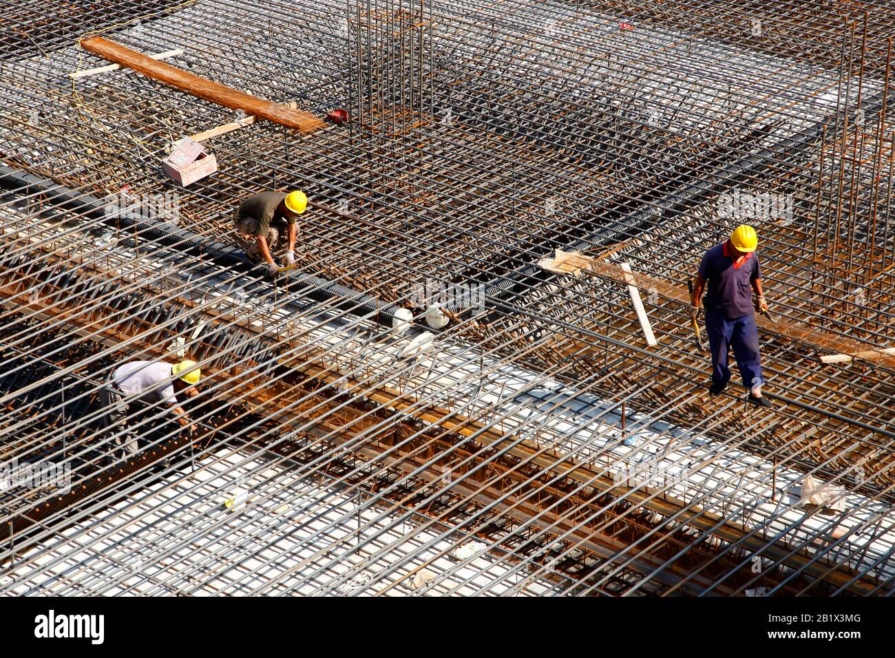 worker in the construction site making reinforcement metal framework ...