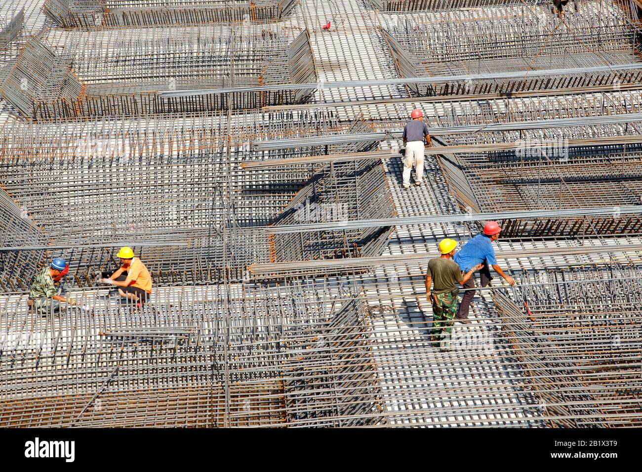 worker in the construction site making reinforcement metal framework ...