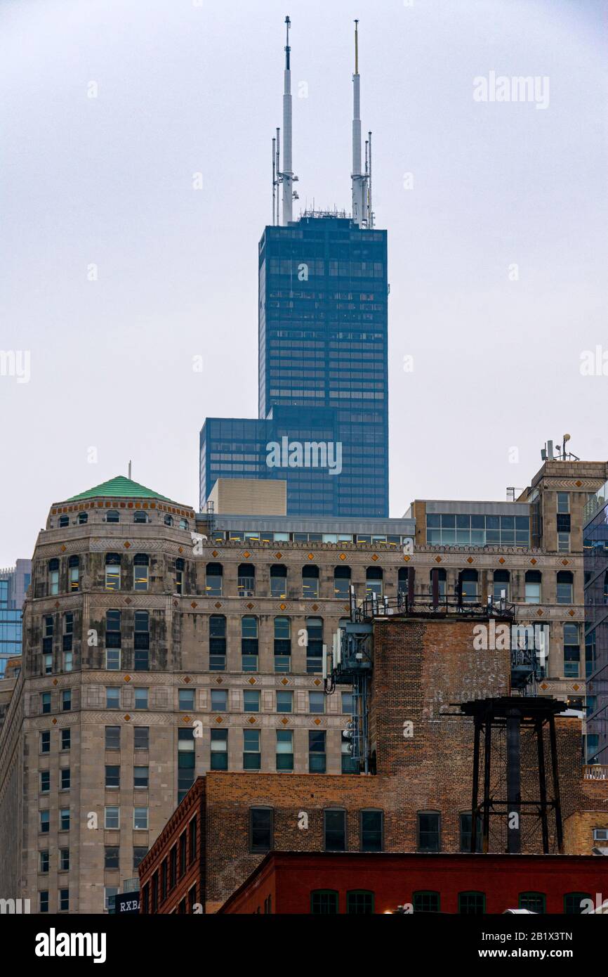 Top of the Willis Tower emerging behind the Merchandise Mart in Chicago, Illinois. Stock Photo