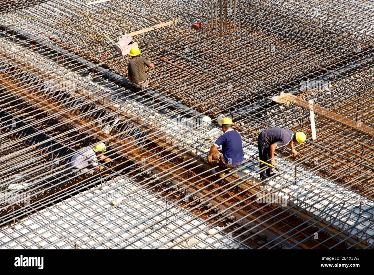 worker in the construction site making reinforcement metal framework ...