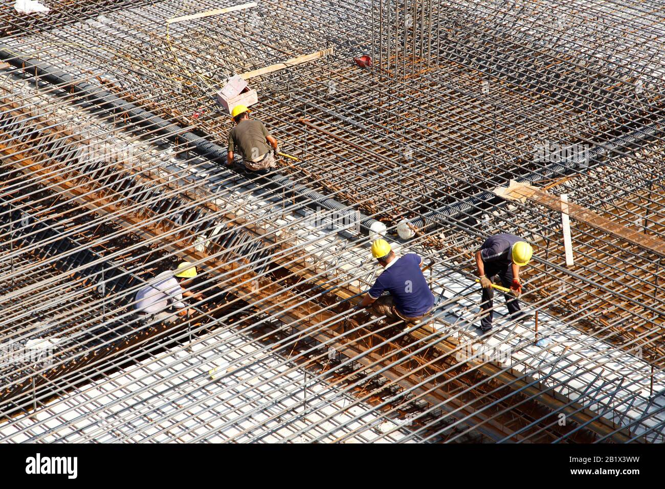 worker in the construction site making reinforcement metal framework ...