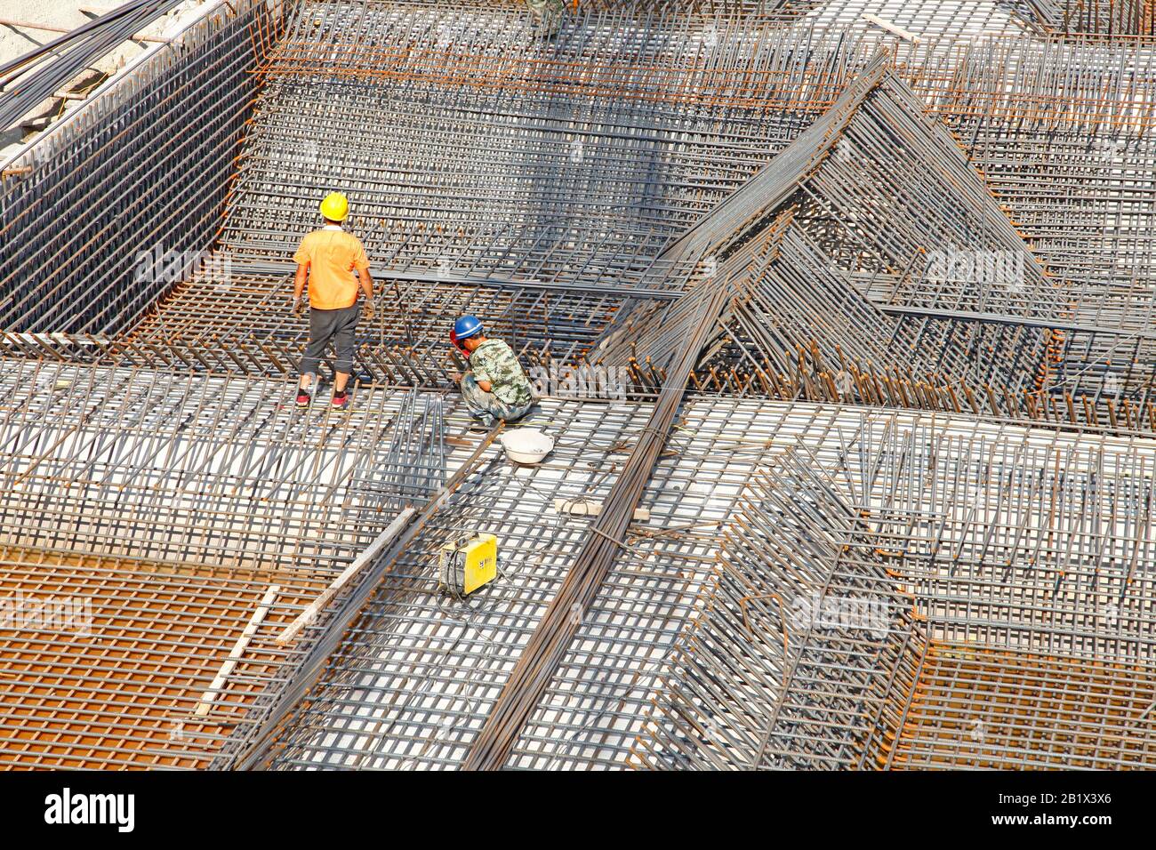 worker in the construction site making reinforcement metal framework ...