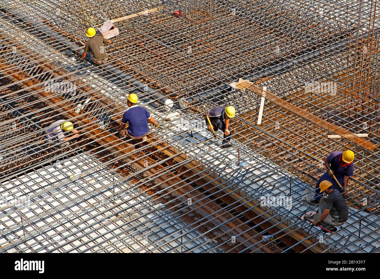 worker in the construction site making reinforcement metal framework ...