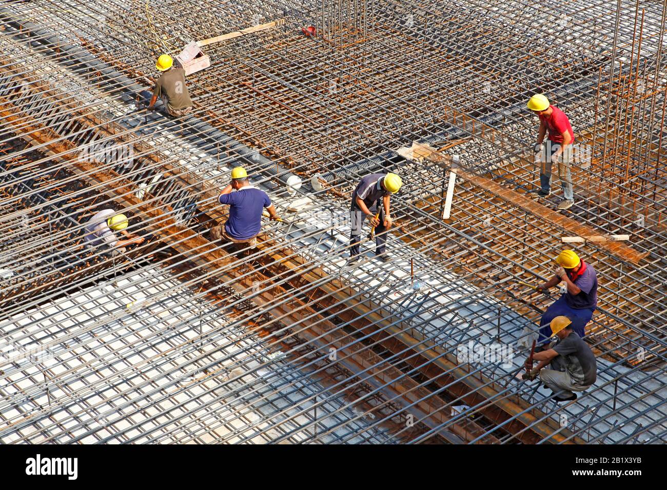 worker in the construction site making reinforcement metal framework ...