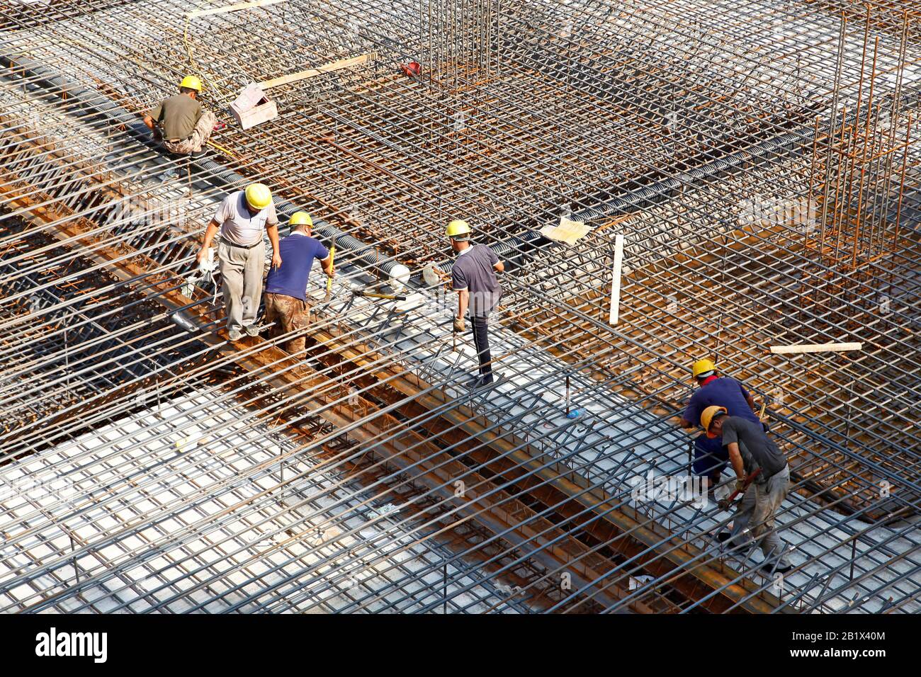 worker in the construction site making reinforcement metal framework ...