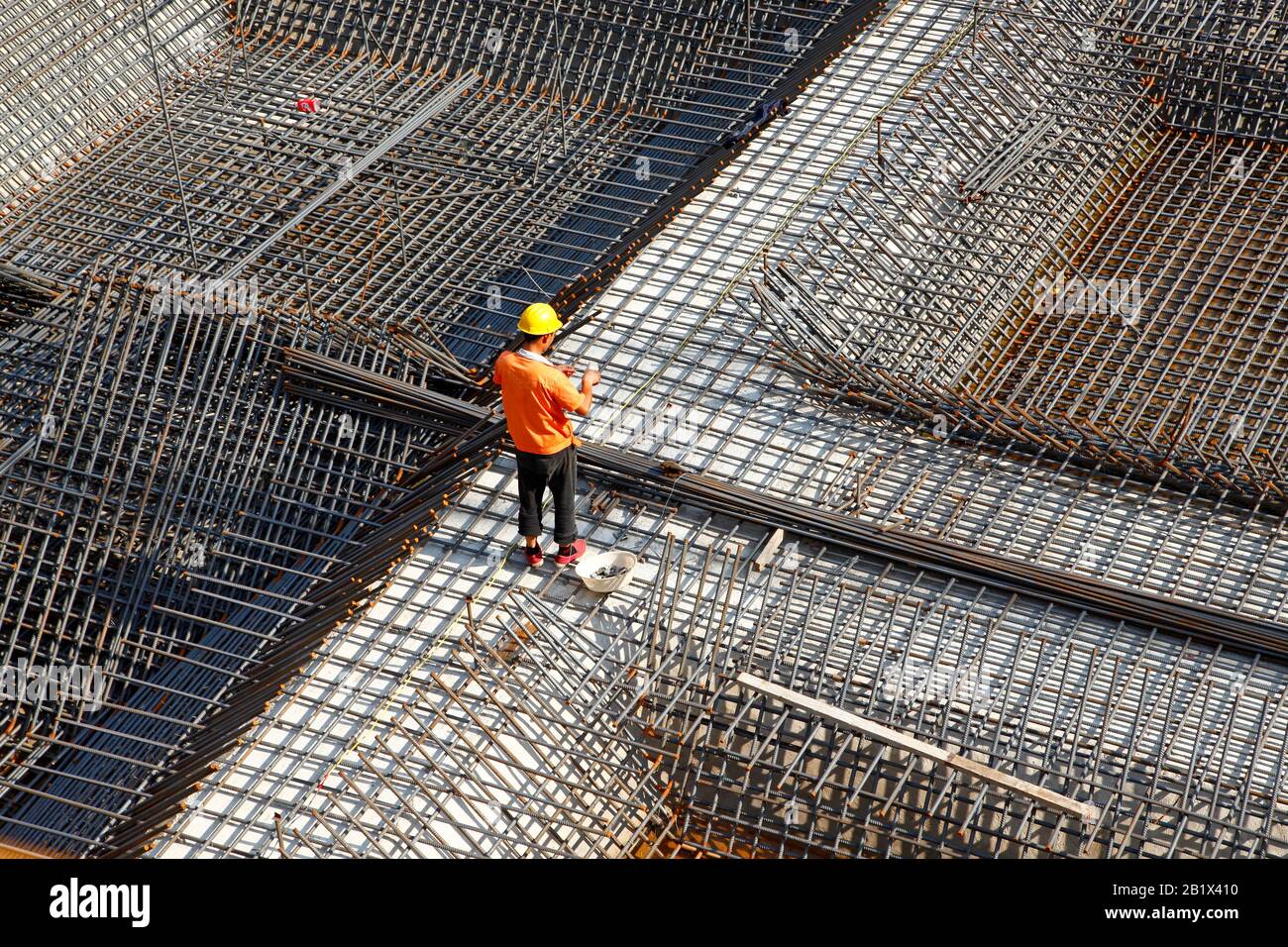 worker in the construction site making reinforcement metal framework ...