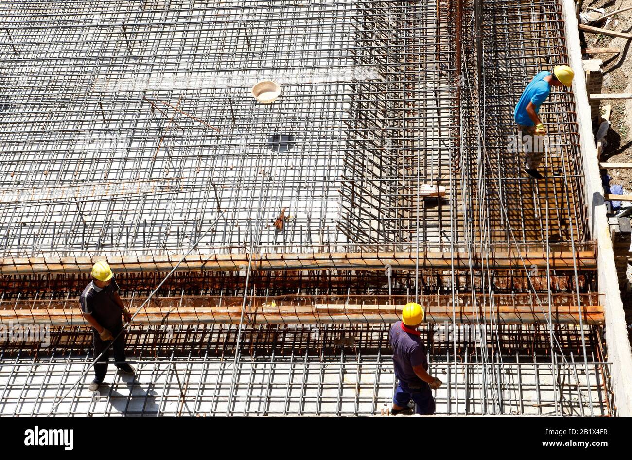 worker in the construction site making reinforcement metal framework ...